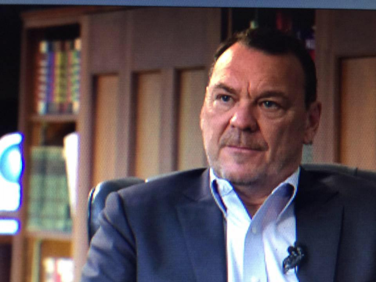 Lloyd K. Benedict Sitting in front of camera in his office