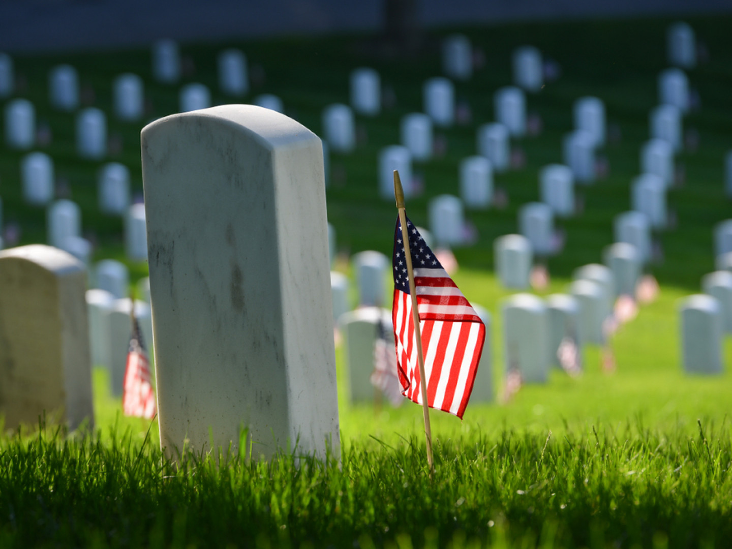 Tombstones on top of graveyards with US Flag